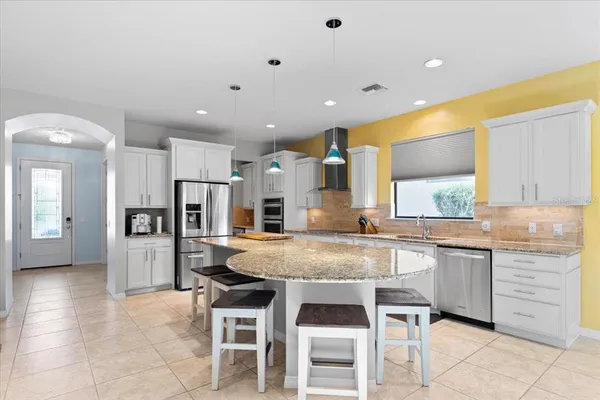 a kitchen with refrigerator and cabinets