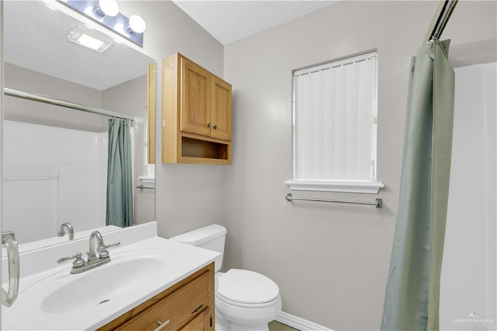 1702 Aries Street Mission, TX 78572 - Photo 11 of 19 a bathroom with a sink a toilet and mirror