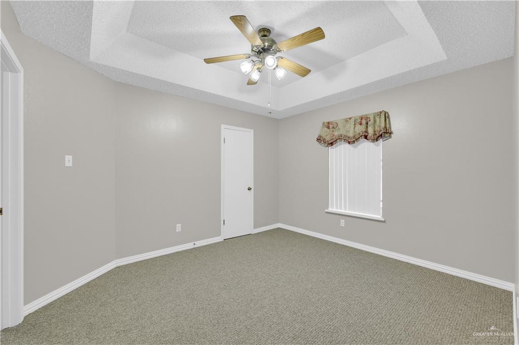 1702 Aries Street Mission, TX 78572 - Photo 12 of 19 an empty room with a window and a ceiling fan