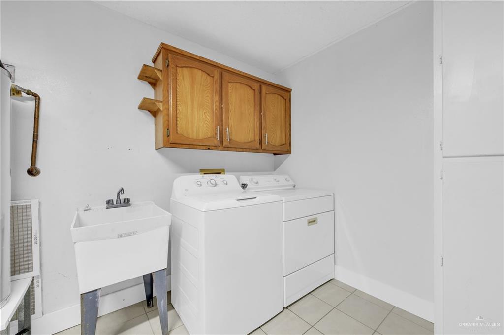 1702 Aries Street Mission, TX 78572 - Photo 15 of 19 a bathroom with a sink and a mirror