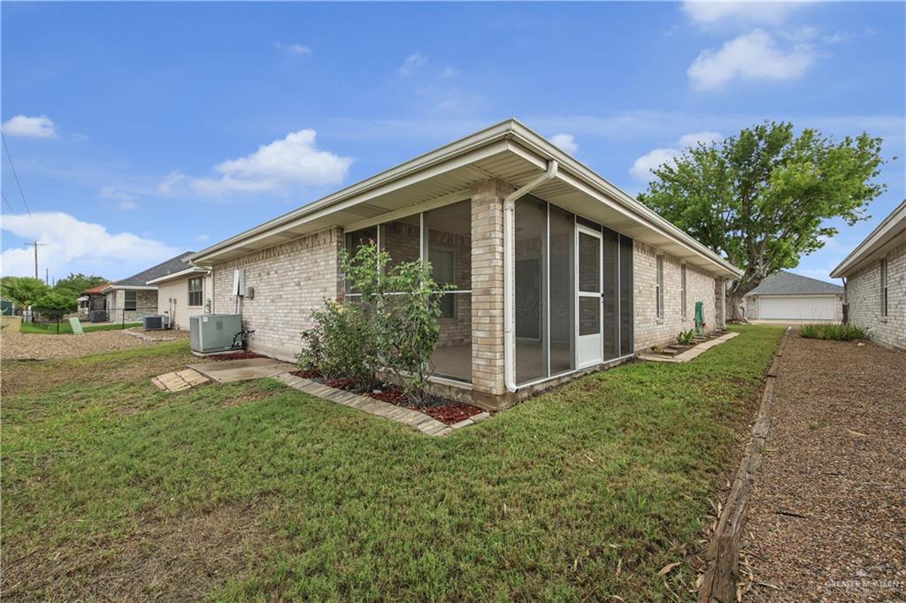 1702 Aries Street Mission, TX 78572 - Photo 18 of 19 a front view of a house with garden