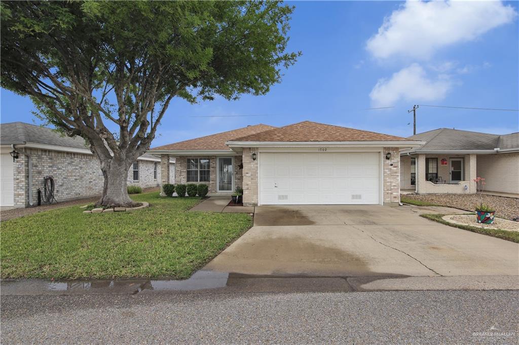 1702 Aries Street Mission, TX 78572 - Photo 19 of 19 front view of a house with a garden