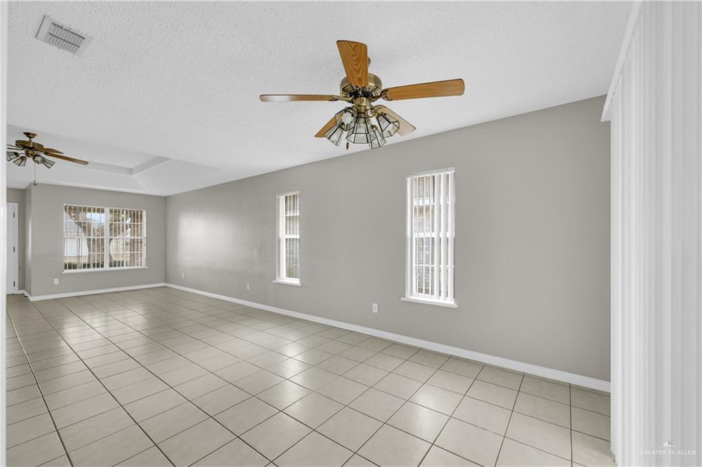 1702 Aries Street Mission, TX 78572 - Photo 5 of 19 an empty room with windows and fan