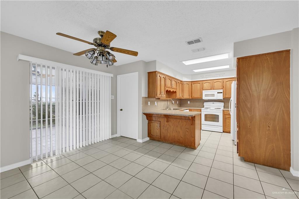 1702 Aries Street Mission, TX 78572 - Photo 6 of 19 a kitchen with stainless steel appliances granite countertop a refrigerator and a sink
