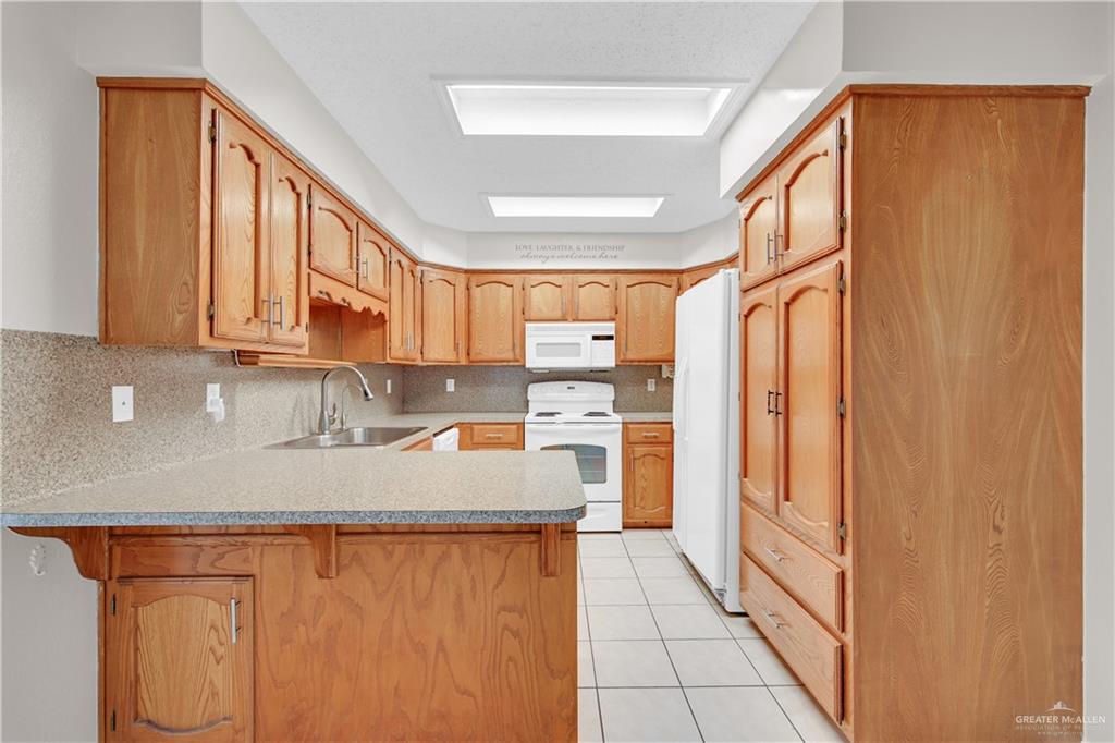 1702 Aries Street Mission, TX 78572 - Photo 7 of 19 a kitchen with stainless steel appliances granite countertop a refrigerator and a sink