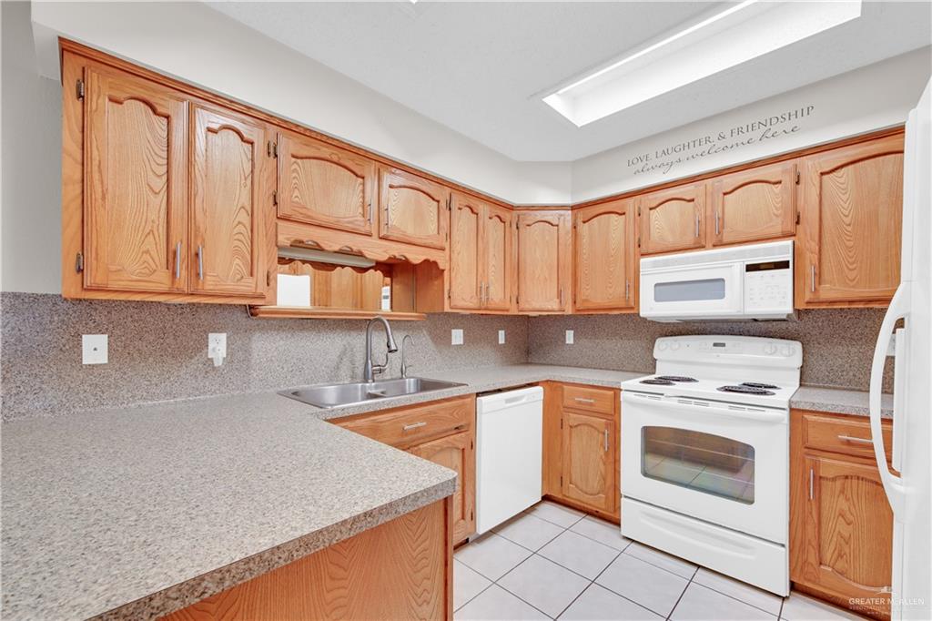 1702 Aries Street Mission, TX 78572 - Photo 8 of 19 a kitchen with stainless steel appliances granite countertop a stove sink and cabinets