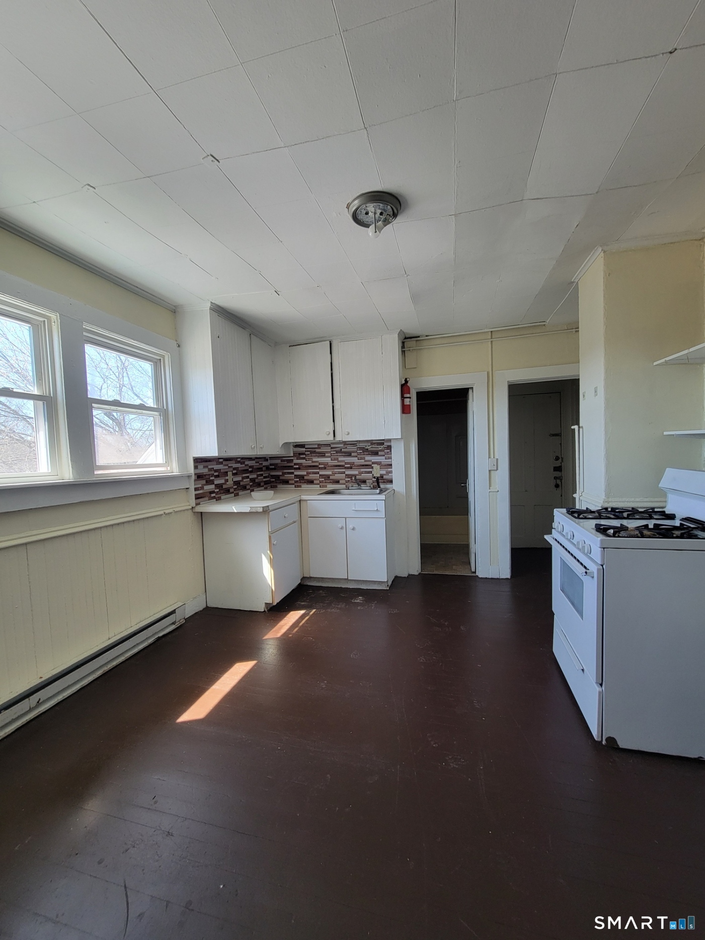 120 North Street, Unit 3 Windham, CT 06226 - Photo 6 of 11 a kitchen with stainless steel appliances granite countertop a stove a sink and a refrigerator