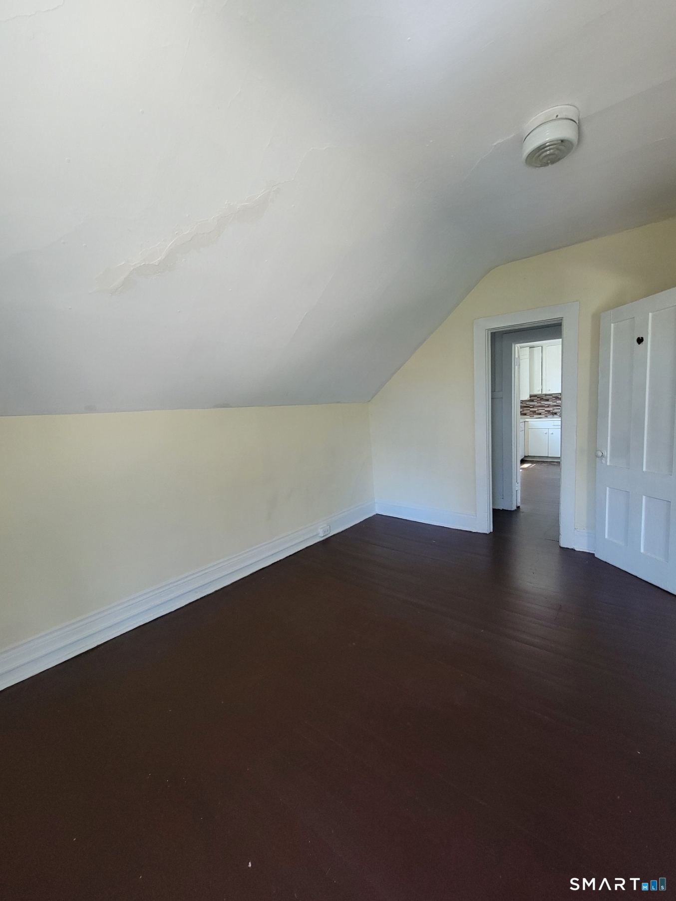 120 North Street, Unit 3 Windham, CT 06226 - Photo 8 of 11 a view of an empty room with wooden floor and a window