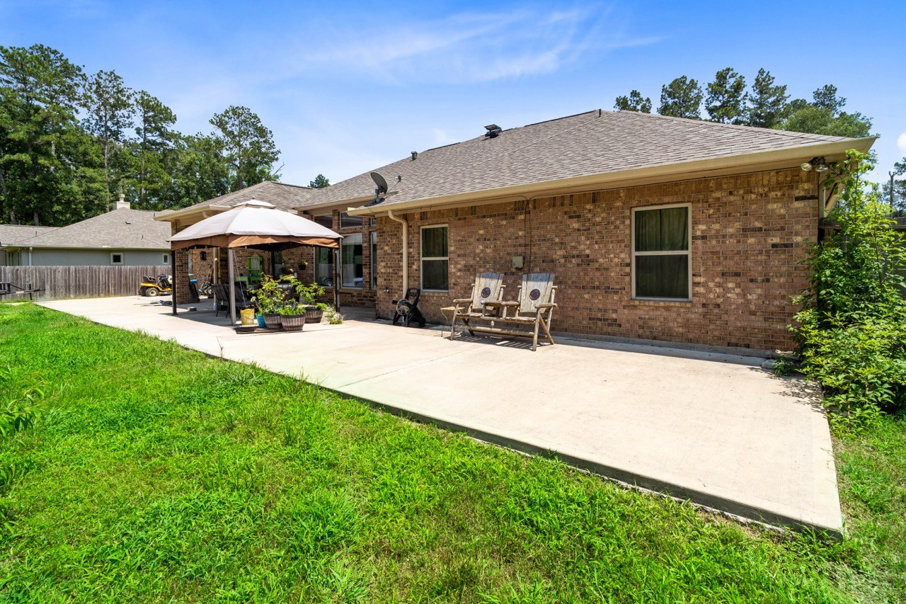 27585 Rio Blanco Drive Splendora, TX 77372 - Photo 32 of 39 So much room on this back patio! Add an outdoor kitchen and make it a nice gathering space.
