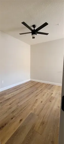 a view of a room with wooden floor