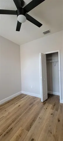 an empty room with wooden floor