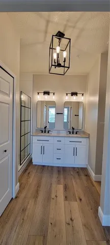 a view of a bathroom with a sink and a mirror