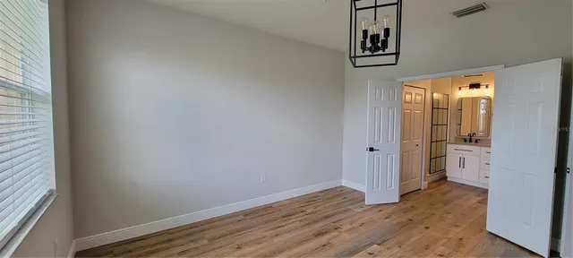a view of hallway with wooden floor