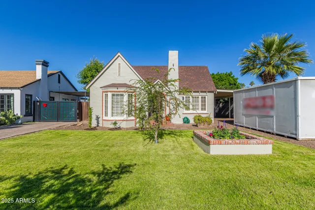 a front view of house with yard outdoor seating and green space