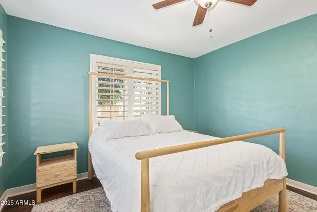 a bedroom with a bed and a large window