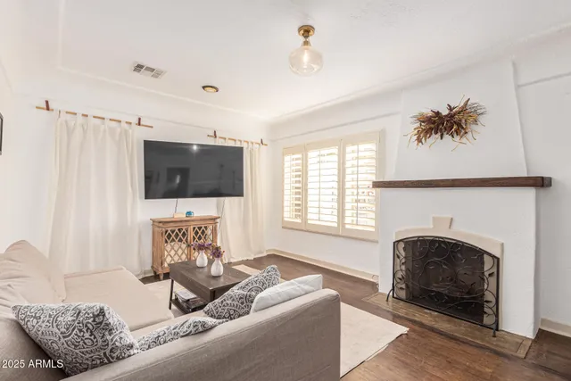 a living room with furniture tv and a window