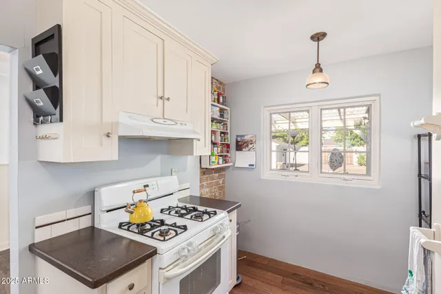 a sink with a cabinets and window