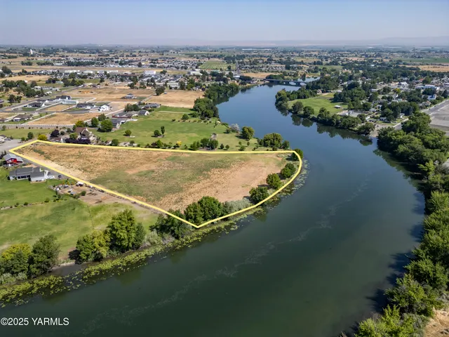 an aerial view of residential houses with outdoor space and river