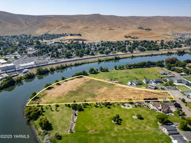 an aerial view of residential houses with outdoor space and river