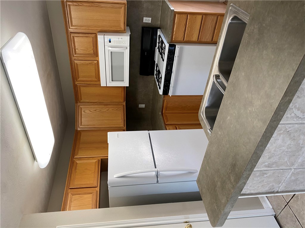 2429 Pintail Loop College Station, TX 77845 - Photo 2 of 20 a kitchen with granite countertop a refrigerator stove top oven a sink and dishwasher