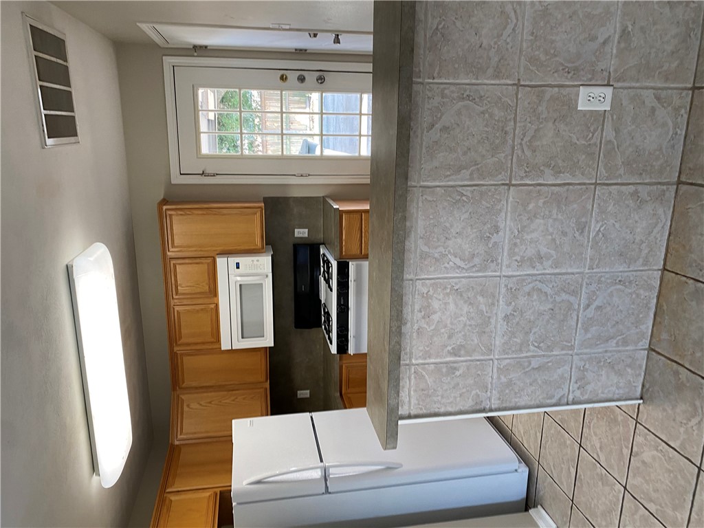 2429 Pintail Loop College Station, TX 77845 - Photo 5 of 20 a kitchen with stainless steel appliances a sink stove and a refrigerator
