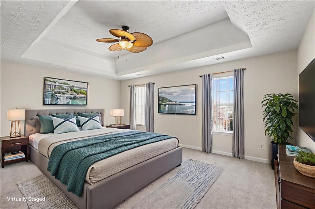 110 Pendergrass Farms Circle Pendergrass, GA 30567 - Photo 15 of 33 a bedroom with a bed and a chandelier