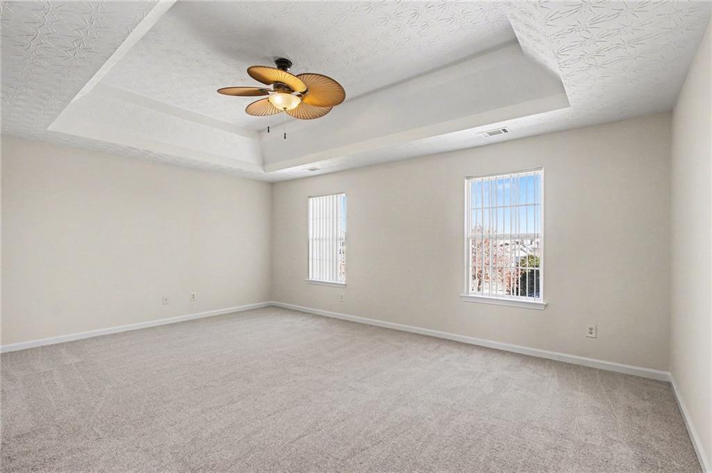 110 Pendergrass Farms Circle Pendergrass, GA 30567 - Photo 16 of 33 an empty room with a window and a chandelier fan