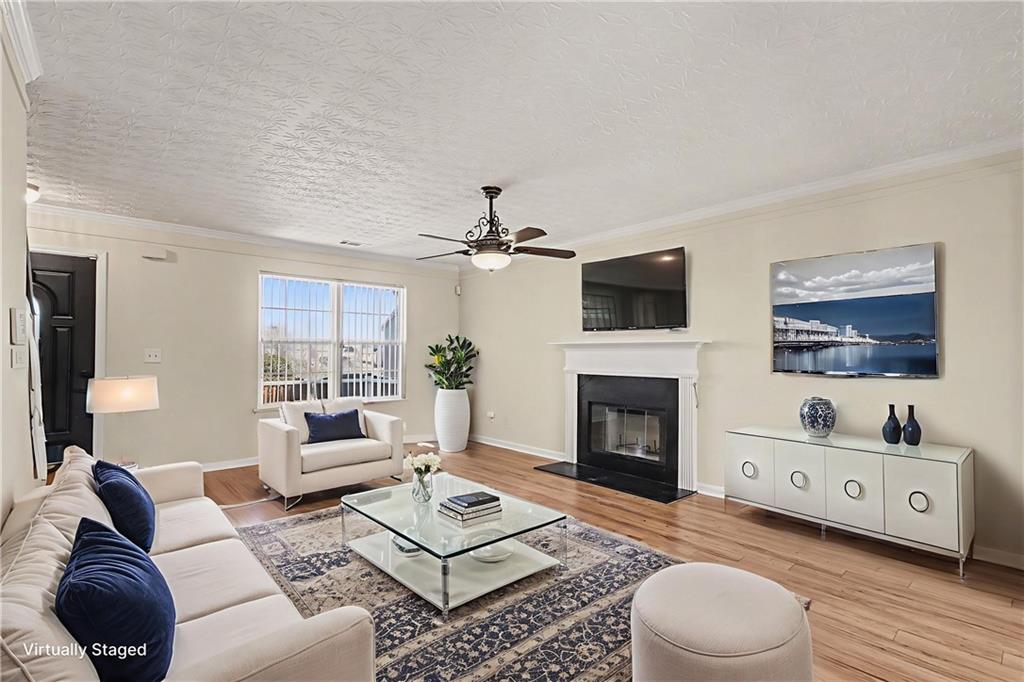 110 Pendergrass Farms Circle Pendergrass, GA 30567 - Photo 4 of 33 a living room with furniture a fireplace and a flat screen tv