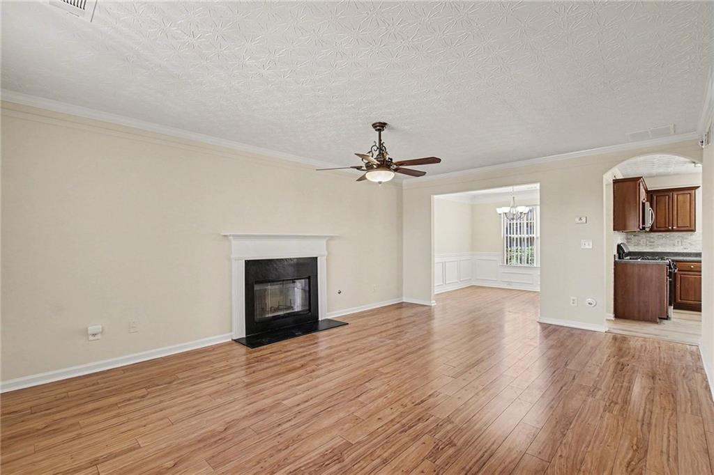 110 Pendergrass Farms Circle Pendergrass, GA 30567 - Photo 6 of 33 an empty room with wooden floor fireplace and windows