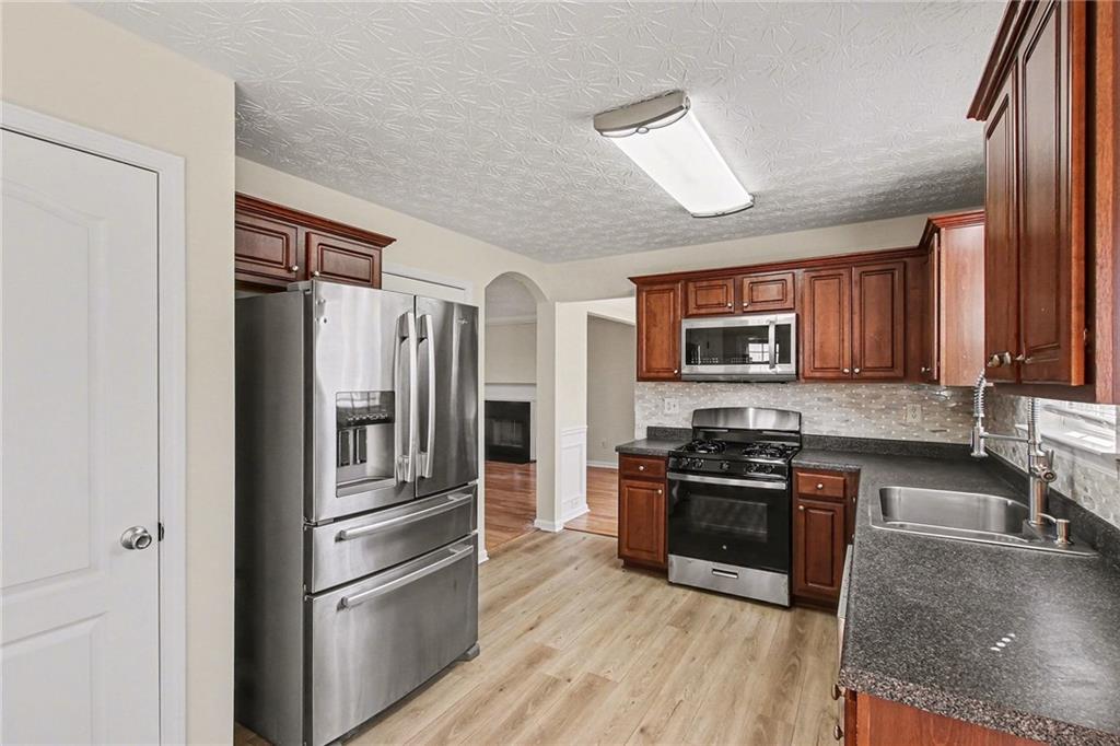 110 Pendergrass Farms Circle Pendergrass, GA 30567 - Photo 10 of 33 a kitchen with stainless steel appliances granite countertop a refrigerator stove and sink