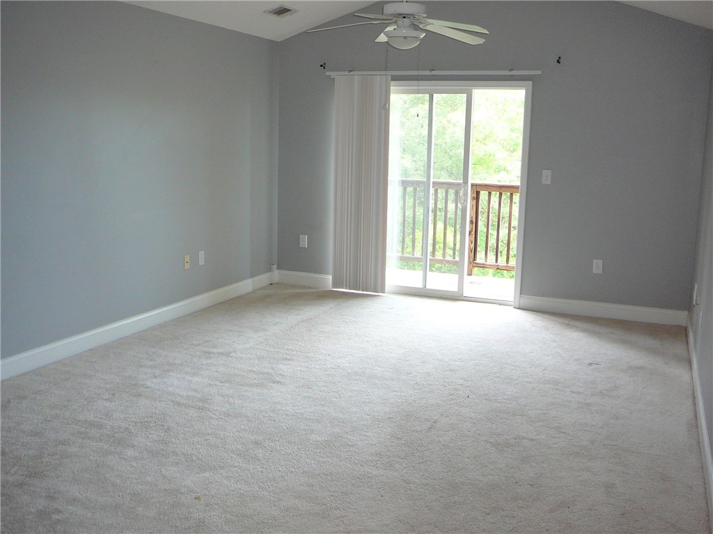 131 Lookover Drive Anderson, SC 29621 - Photo 6 of 18 A spacious primary bedroom with a vaulted ceiling and direct access to a private balcony.