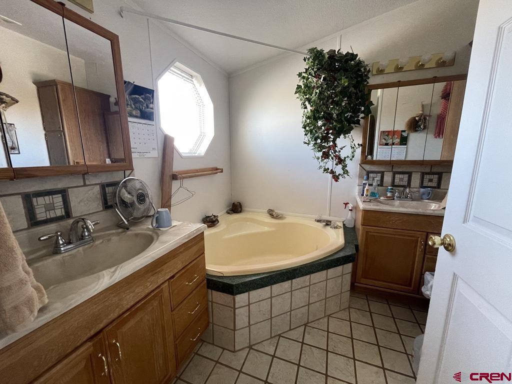 12383 Rd M Cahone, CO 81320 - Photo 26 of 42 a bathroom with a sink a toilet and a mirror