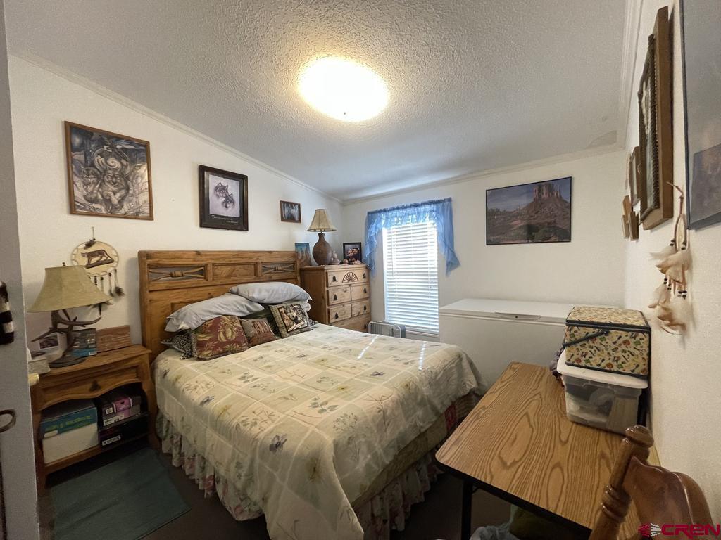 12383 Rd M Cahone, CO 81320 - Photo 27 of 42 a bedroom with a bed and a flat screen tv