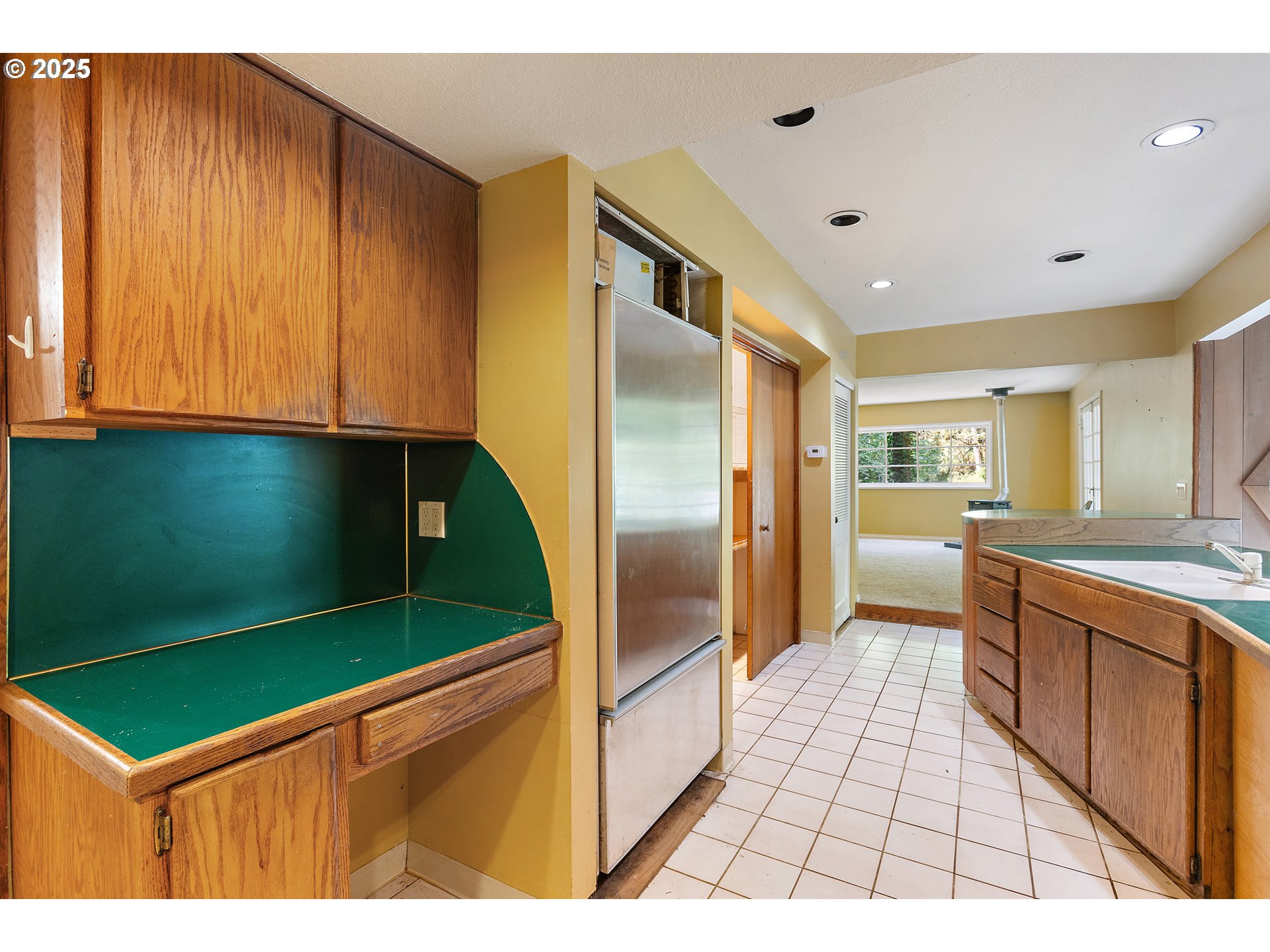 6131 Northwest Thompson Road Portland, OR 97210 - Photo 13 of 48 a kitchen with stainless steel appliances kitchen island granite countertop a refrigerator and a stove top oven