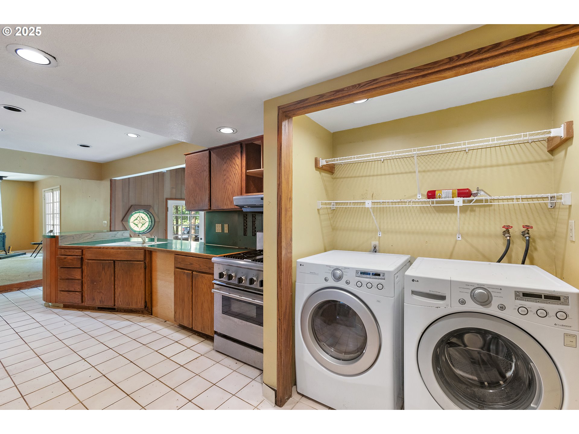 6131 Northwest Thompson Road Portland, OR 97210 - Photo 14 of 48 a view of a kitchen with washer and dryer