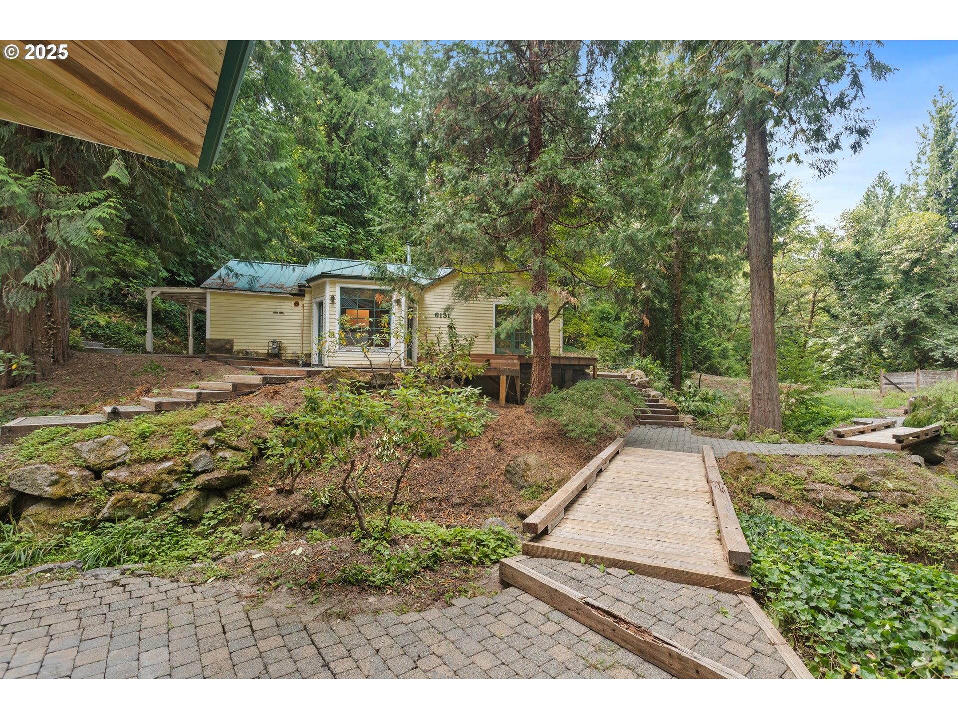 6131 Northwest Thompson Road Portland, OR 97210 - Photo 2 of 48 a backyard of a house with garden and outdoor seating