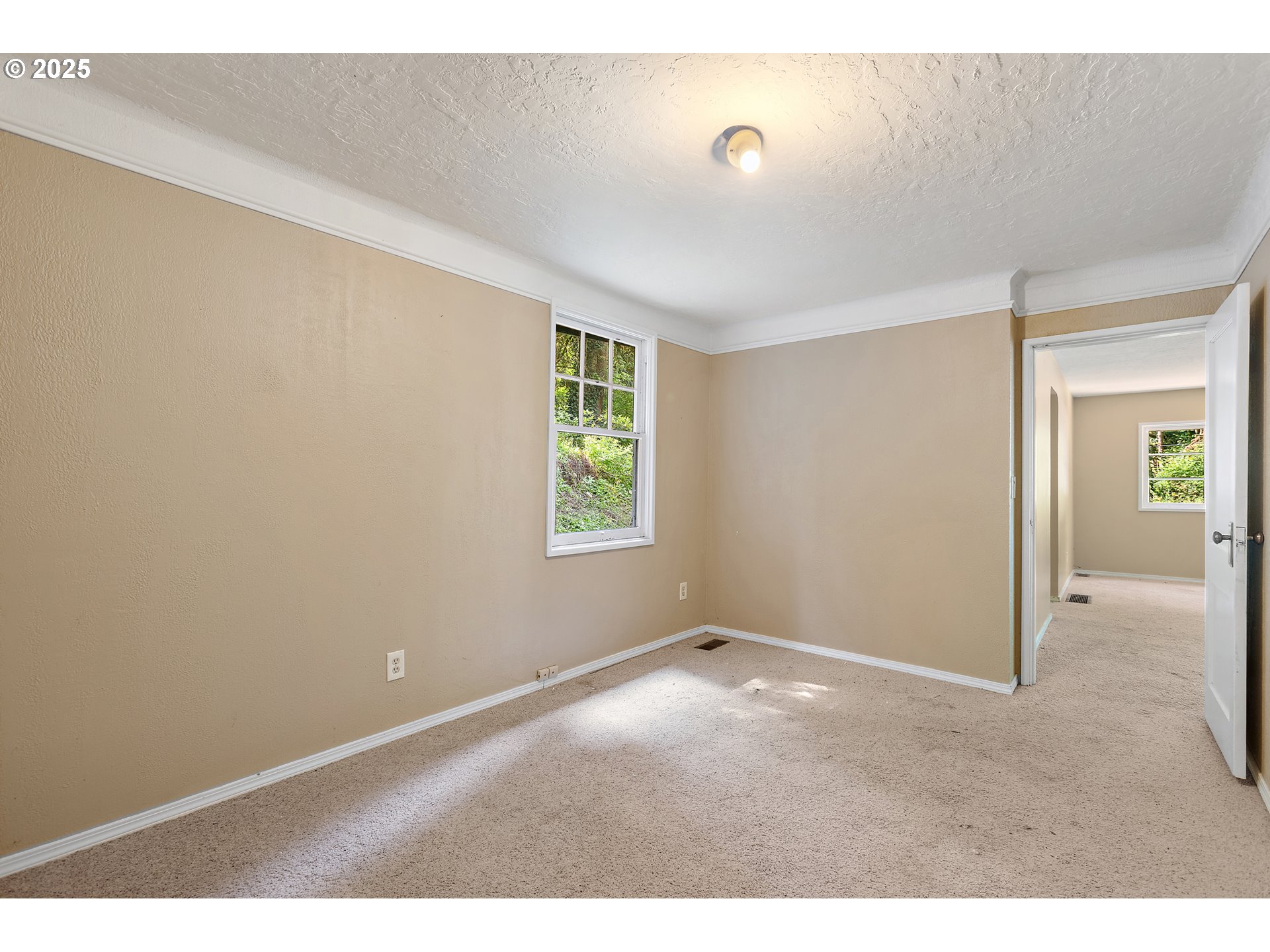 6131 Northwest Thompson Road Portland, OR 97210 - Photo 22 of 48 a view of an empty room with closet and a window