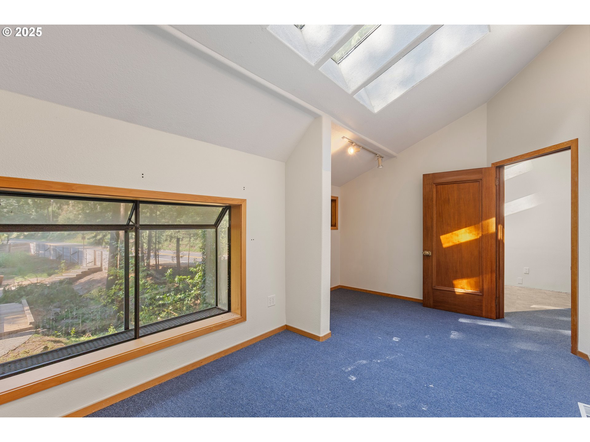 6131 Northwest Thompson Road Portland, OR 97210 - Photo 36 of 48 a view of an empty room with a window and wooden floor
