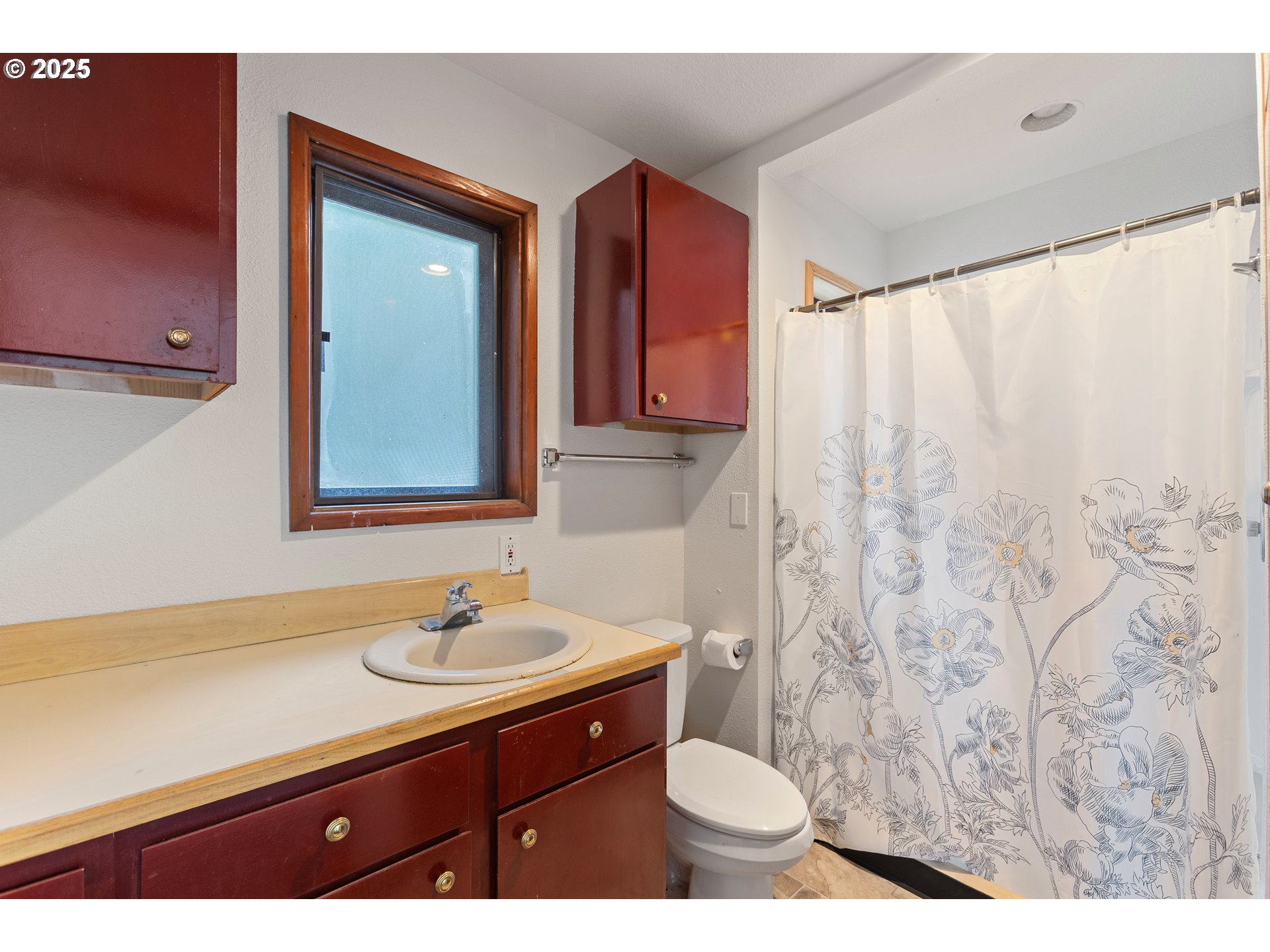 6131 Northwest Thompson Road Portland, OR 97210 - Photo 39 of 48 a bathroom with a sink toilet a mirror and vanity