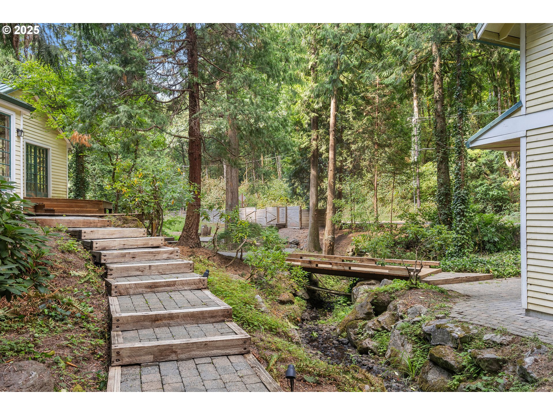 6131 Northwest Thompson Road Portland, OR 97210 - Photo 43 of 48 a view of a yard with plants and large trees