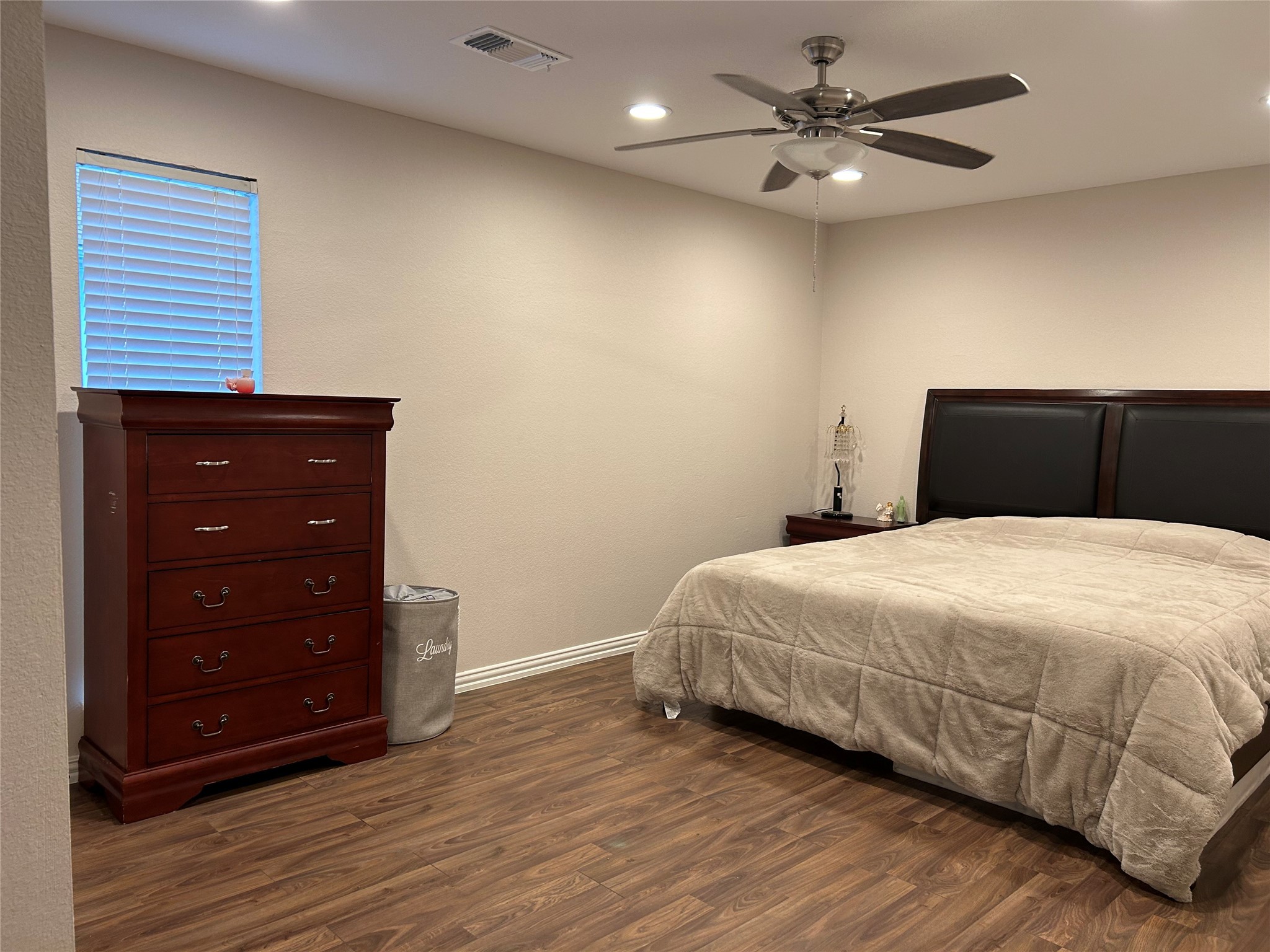 306 Isles End Road Tiki Island, TX 77554 - Photo 14 of 25 a bedroom with a bed and a dresser