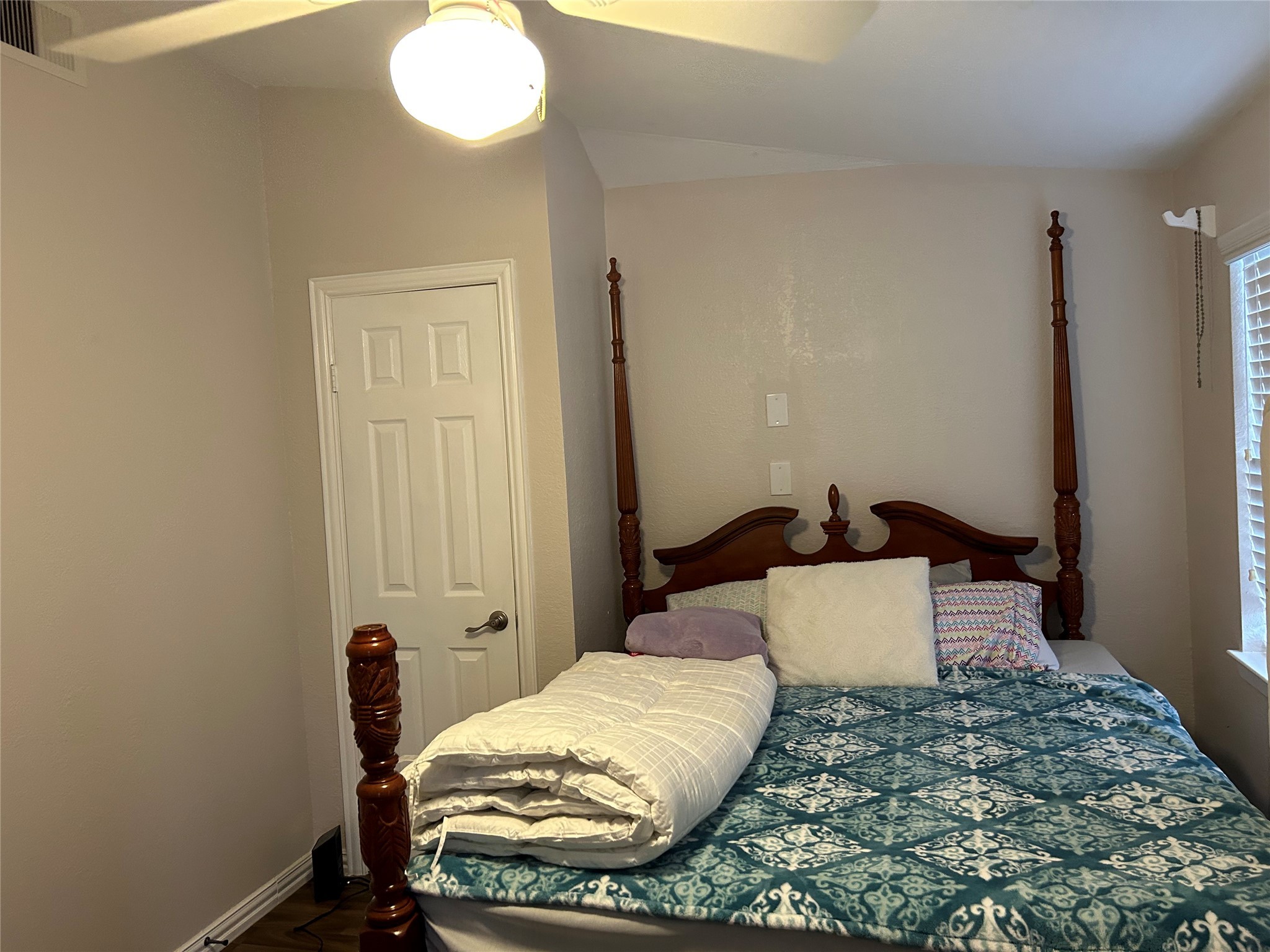 306 Isles End Road Tiki Island, TX 77554 - Photo 18 of 25 a bedroom with a bed and wooden floor