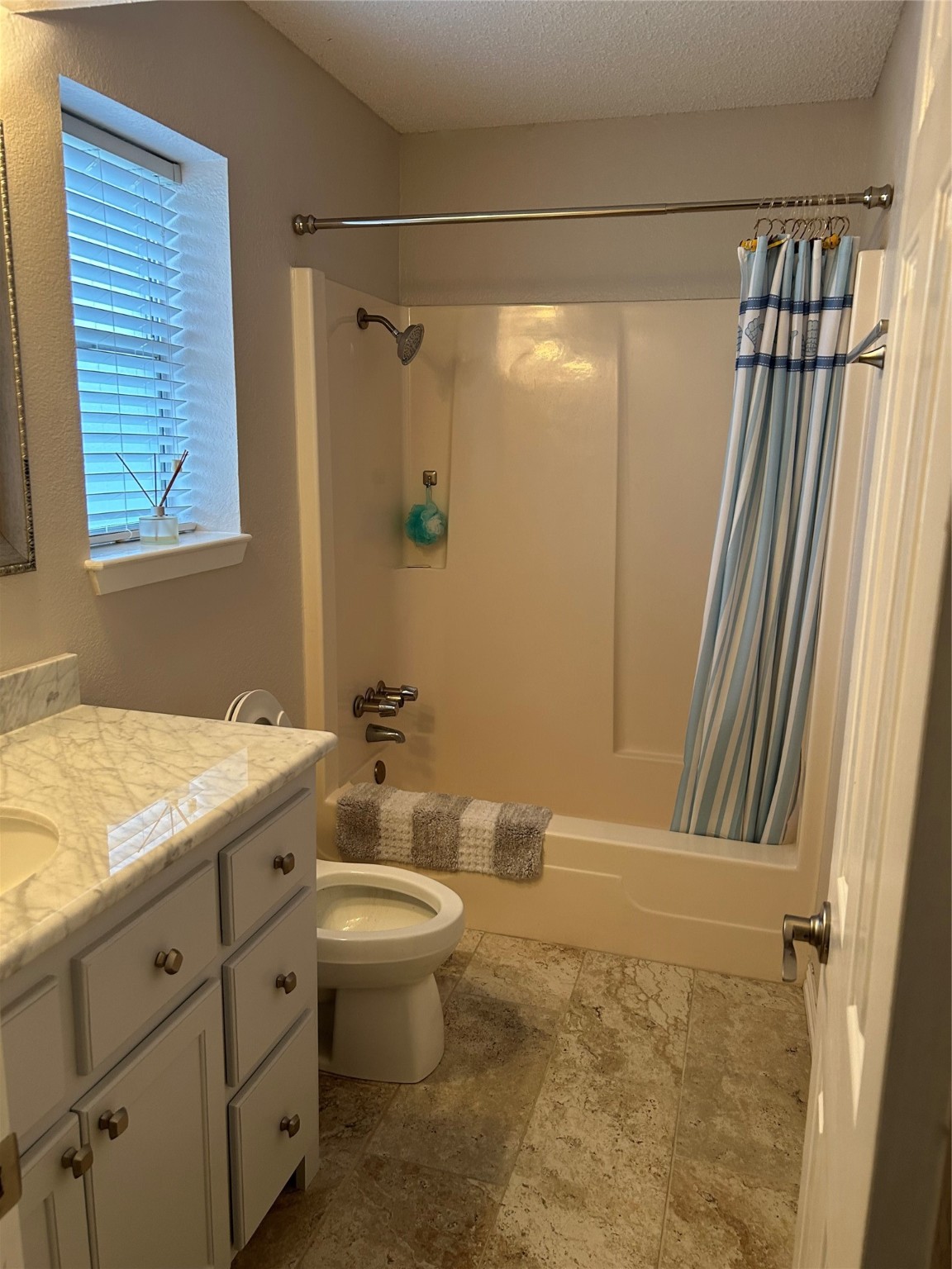306 Isles End Road Tiki Island, TX 77554 - Photo 19 of 25 a bathroom with a granite countertop sink toilet and shower