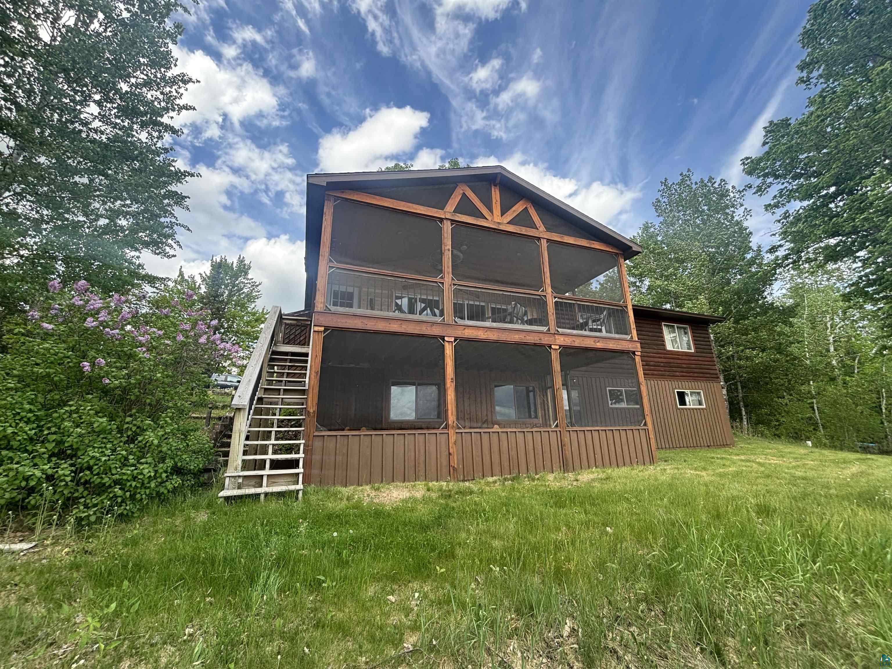 444 Fernberg Road, Unit 11 Ely, MN 55731 - Photo 1 of 20 Two-story property featuring a screened-in porch on both levels