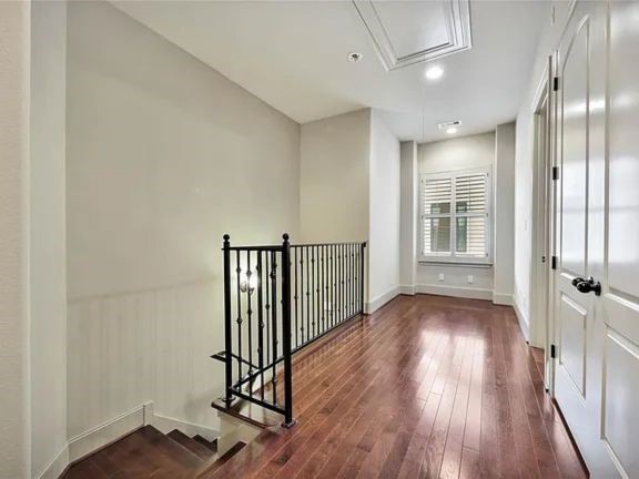 910 Snover Street, Unit A Houston, TX 77007 - Photo 11 of 26 an empty room with wooden floor and windows