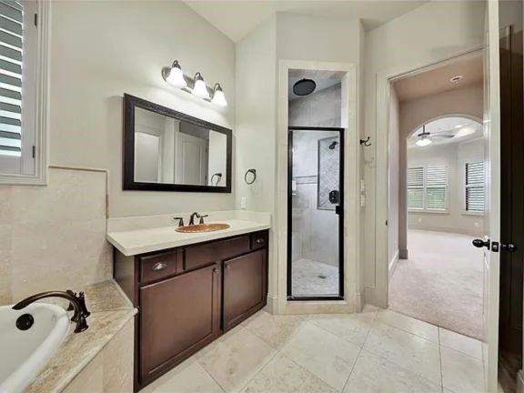 910 Snover Street, Unit A Houston, TX 77007 - Photo 18 of 26 a bathroom with a bathtub sink mirror and shower