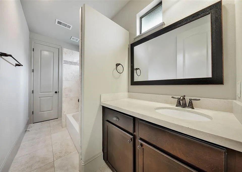 910 Snover Street, Unit A Houston, TX 77007 - Photo 20 of 26 a bathroom with a sink and a mirror