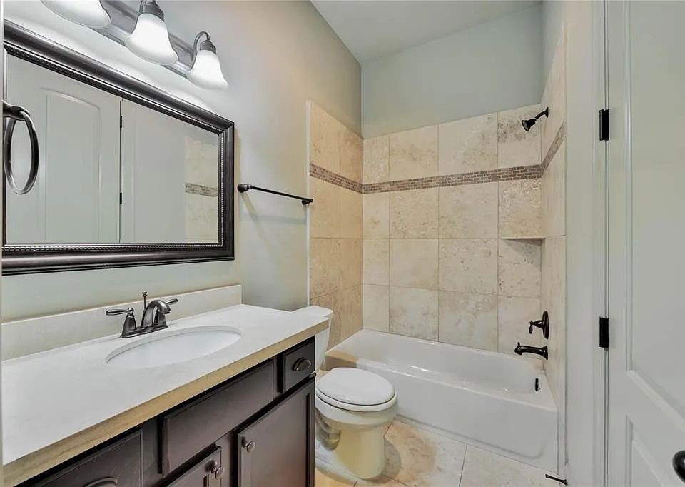 910 Snover Street, Unit A Houston, TX 77007 - Photo 23 of 26 a bathroom with a sink a toilet and shower