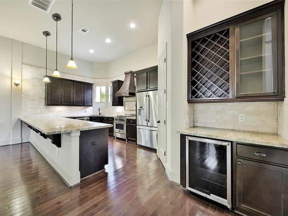 910 Snover Street, Unit A Houston, TX 77007 - Photo 4 of 26 a kitchen with stainless steel appliances kitchen island granite countertop a stove a sink and a refrigerator