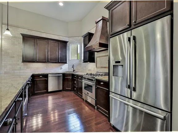 910 Snover Street, Unit A Houston, TX 77007 - Photo 8 of 26 a kitchen with granite countertop stainless steel appliances and wooden cabinets